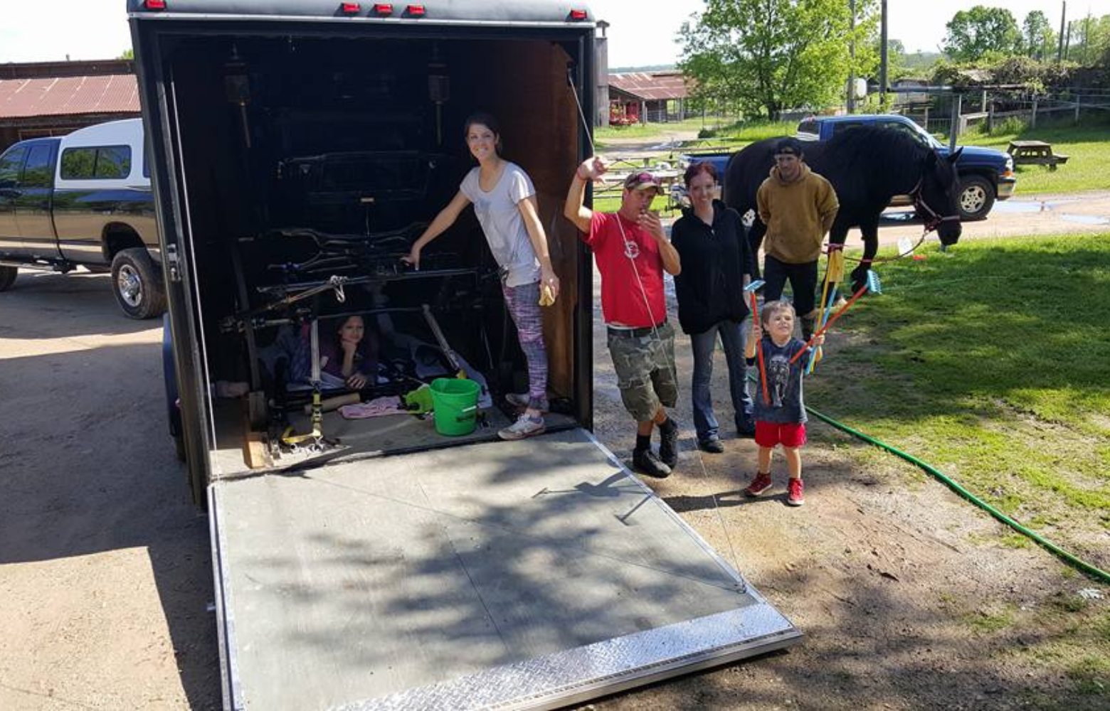 Team at Cavanaugh Carriages loading a horse-drawn carriage into a trailer, preparing to transport it to their next event.
