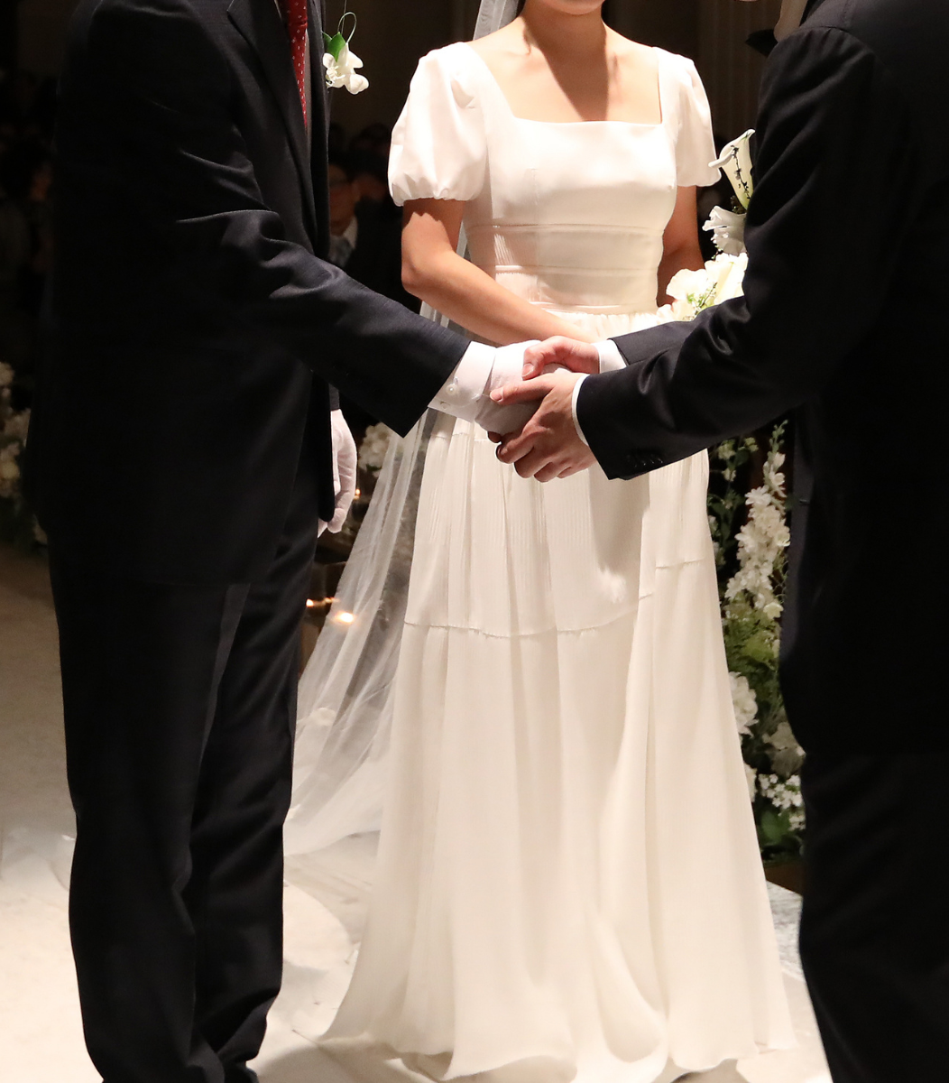 A couple holding hands during a vow renewal ceremony, celebrating love and commitment with Cavanaugh Carriages' special event services