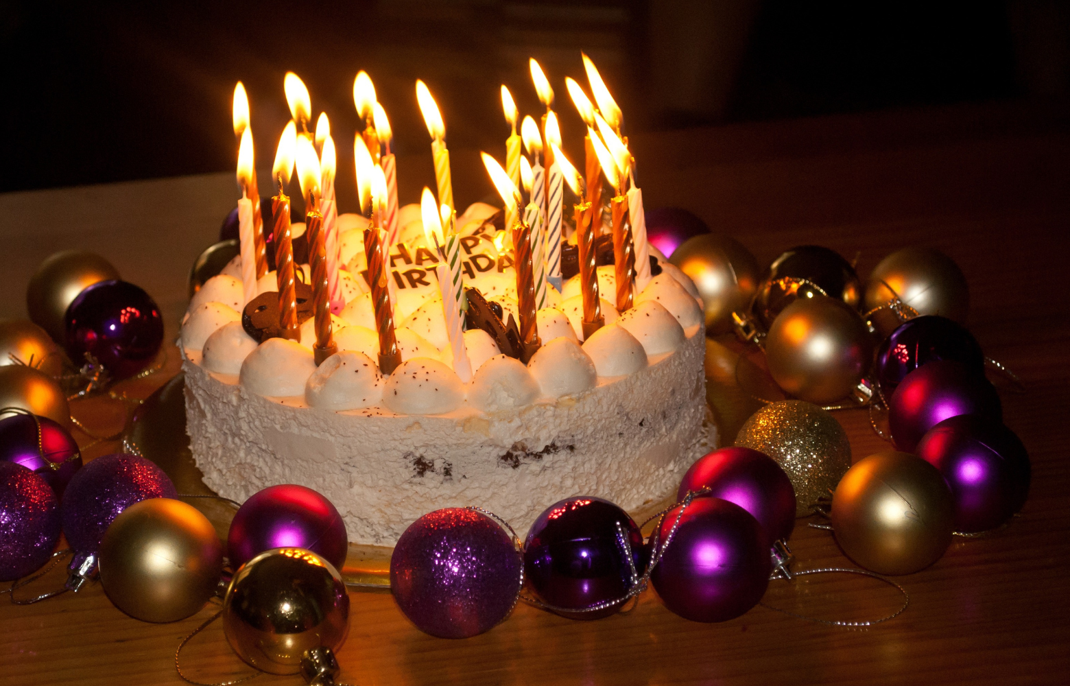 A festive birthday cake surrounded by colorful decorations, symbolizing the exciting birthday celebrations and special milestone events hosted by Cavanaugh Carriages—whether on-site in their party room or at your own location with unique entertainment like a traveling petting zoo.