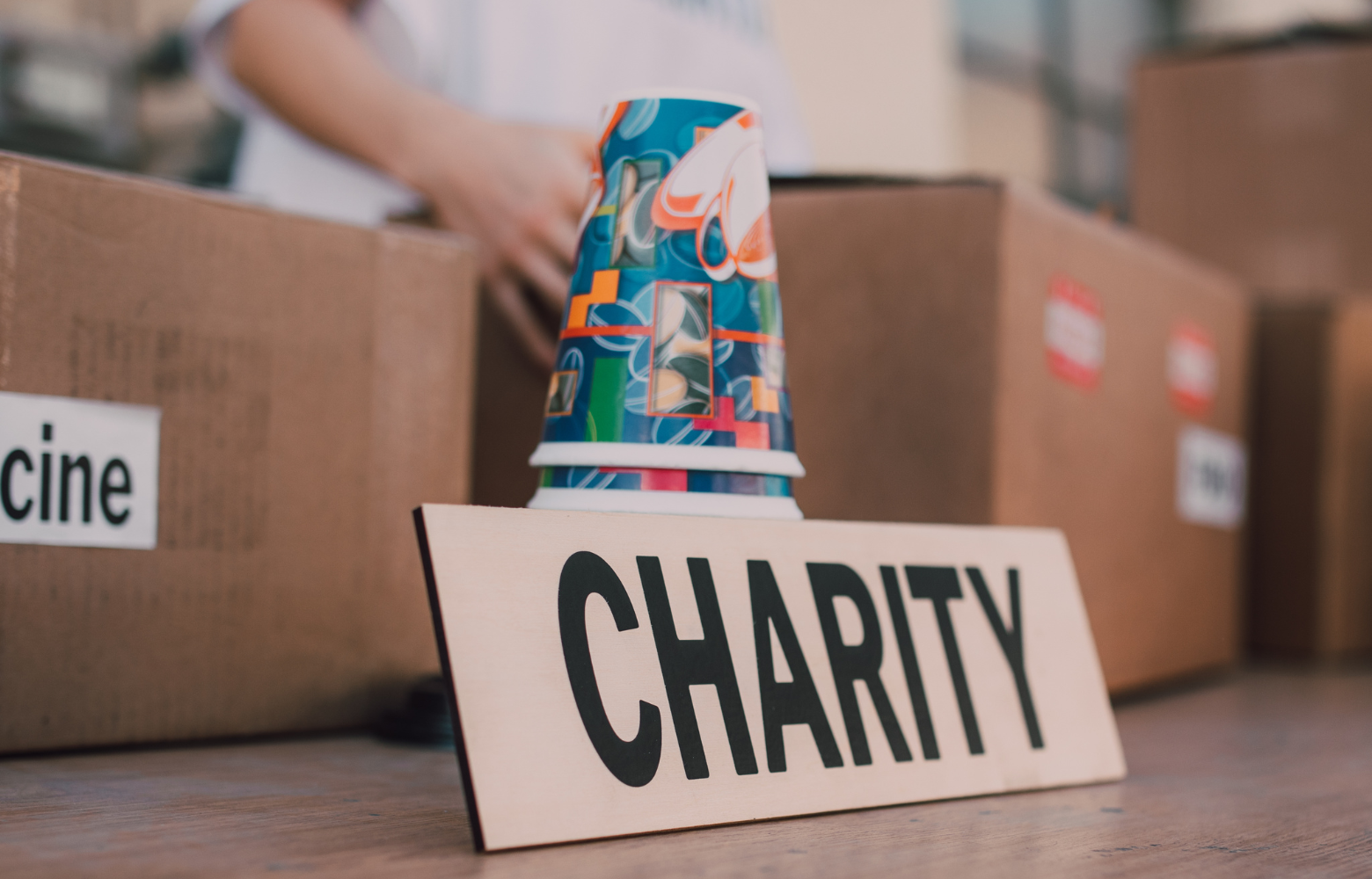 A sign displaying 'Charity,' symbolizing the support Cavanaugh Carriages provides for charitable events by offering unique services like petting zoos and carriage rides to enhance fundraising efforts and community gatherings.